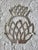 A metal pineapple trivet with hanger, marked 'Italy - Leonard Silverplate'. Measuring approximately 9” x 7 ½” x ½”....