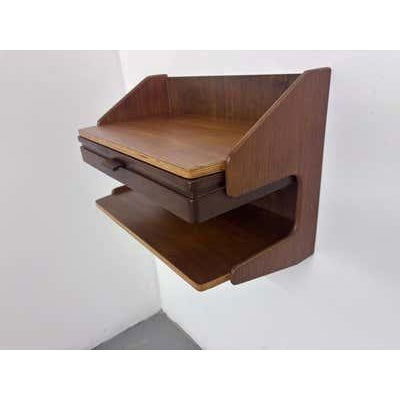 Wall-Mounted Danish Nightstands, each with one pull out drawer and open shelf area below. Signed on back with maker name...