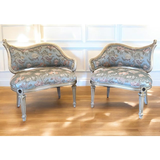 A pair of exquisite Maison Jansen inspire asymmetric chairs, circa 1950s. Framed in paint decorated wood in shades of...