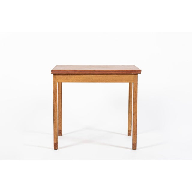 This vintage mid century Danish modern small wooden extendable dining table or game table was designed by Ejner Larsen for...