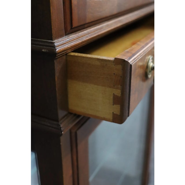 Jasper Cabinet Co. Cherry curio with mirrored back and glass shelving. Two available.