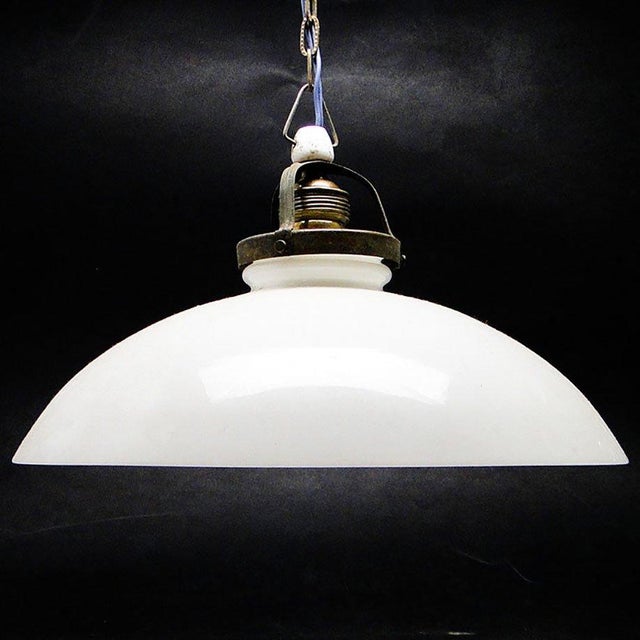 The pendant lamp was produced in the 50s. The construction is brass, glass lampshade. It is preserved in very good...