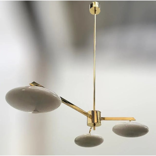 Italian pendant with three glossy gray Murano glass shades mounted on solid brass frame in lacquered polished brass finish...