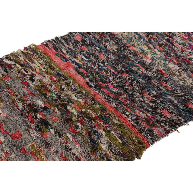 Hand-knotted in wool and originating from Morocco circa 1950-1960, this 3x6 special vintage rug features a colorful boho...