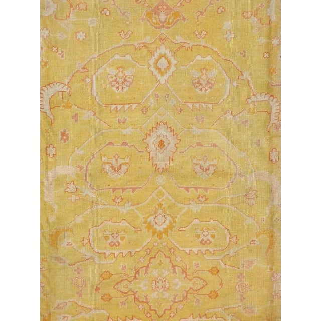A room size early 20th century turkish oushak carpet in predominantly yellow and coral tones