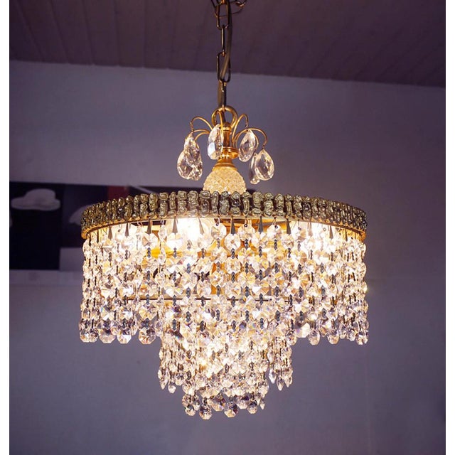 Elegant cascading bubbles chandelier with crystals mounted on a gilt brass frame. Hanging crystals are reminiscent of...