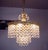 Elegant cascading bubbles chandelier with crystals mounted on a gilt brass frame. Hanging crystals are reminiscent of...