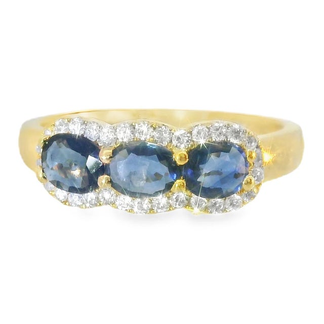 This stunning 18K white gold band ring features a timeless three-stone design, showcasing vibrant natural sapphires...