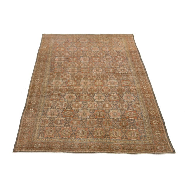 This exquisite antique Persian Malayer rug features a beautiful floral design, showcasing rich shades of gray and rust....