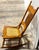 This is an early 20th-Century small rocking chair featuring a classic oak frame with distinctive barley twist spindles...