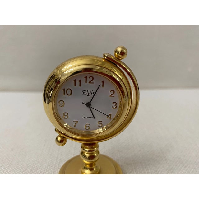 Add timeless charm to your collection with this Vintage “Elgin” Gold Tone Globe Mini Clock. Designed in the shape of a...