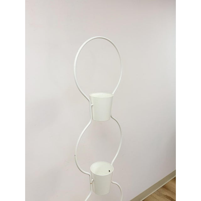 This charming vintage 3-tier white plant stand is a clean and practical mid-century modern display piece. The crisp white...