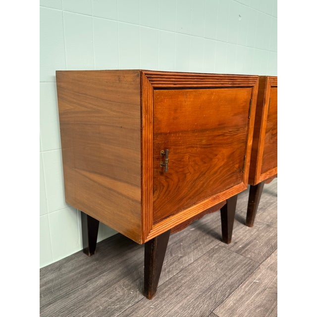 A pair of bedside tables crafted by an Italian carpenter in the 1950s. Constructed of wood with a walnut burl veneer. The...