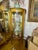 This beautiful piece features a half-round bow-front shape accent by curved glass panels and a mirrored interior backing....