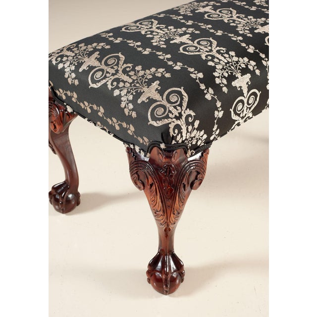Handcrafted in Italy, this upholstered bench features a rectangular cushioned seat supported by carved cabriole legs. A...