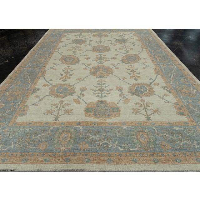 Turkish Oushak Rug Ivory and Sky Blue Handwoven Wool Rug 9'10" x 13'11" This 9'10" x 13'11" Turkish Oushak rug features an...