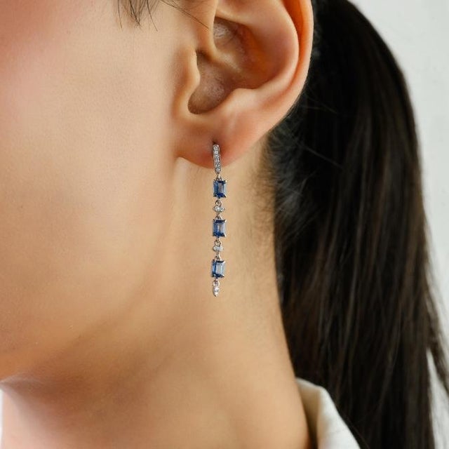 These elegant dangle earrings features 6 octagon cut natural blue sapphires totaling 1.63 carats, set in 14k white gold....