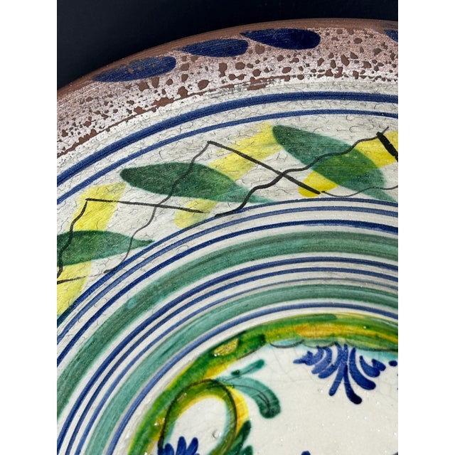 Large basin with a flat base, a very open, truncated cone-shaped eaves and a thick rim from the Seville potteries of...