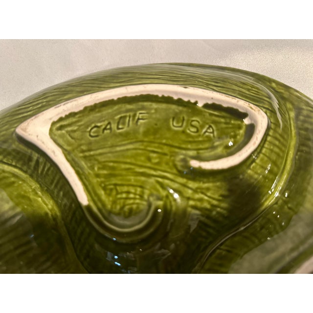 A Mid-Century olive green divided serving dish eith leaf design. Santa Ana California Pottery from the 1960’s. 13” diameter.