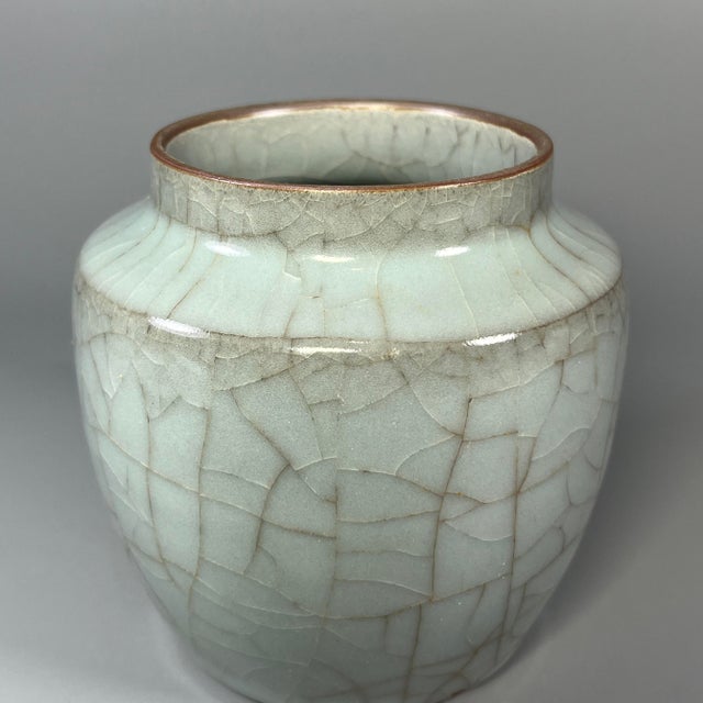 This is a fine vintage Chinese Longquan celadon lidded storage jar. The whole‑body natural crackle‑glaze creates an...