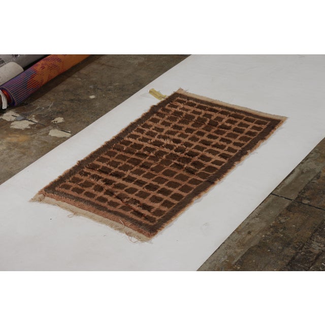 Hand knotted in wool originating from Turkey circa 1950-1960, this vintage rug hails from the mid-century Tulu rug family,...