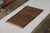 Hand knotted in wool originating from Turkey circa 1950-1960, this vintage rug hails from the mid-century Tulu rug family,...