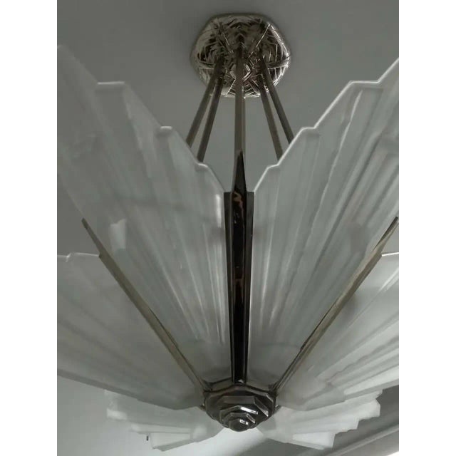 A French Art Deco chandelier with six substantial grand scales by Sabino in great condition. Clear frosted molded glass...