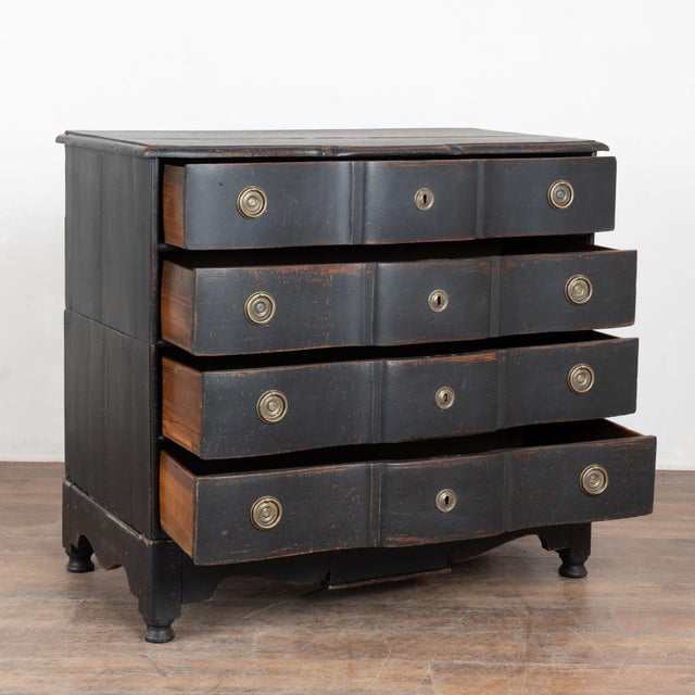 The black finish complements the reserved serpentine curves in this large oak chest of four drawers resting on a scalloped...