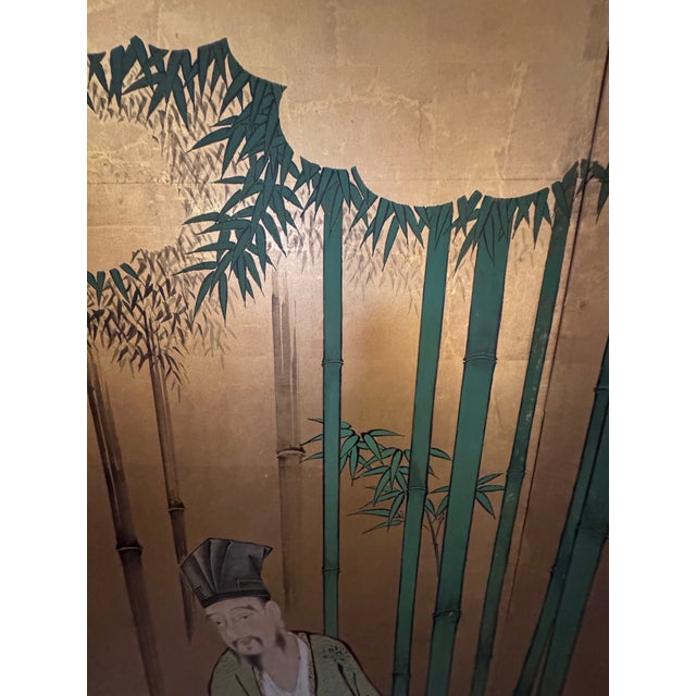 A spectacular monumental six-panel Chinese folding screen featuring an intricately hand-painted gathering of scholars,...