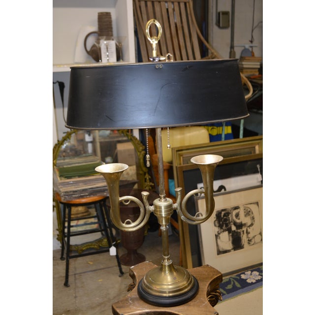 This is a heavy brass table lamp by Wildwood. Works as it should, 2 bulbs with separate chain pulls. The shade is metal....
