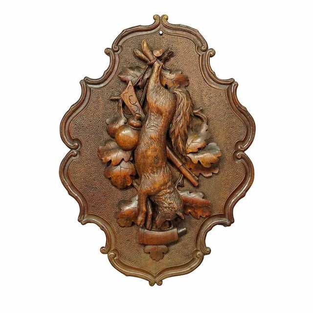 Antique wooden carved black forest game plaque with fox. An antique wooden hunting game plaque with impressive carving of...