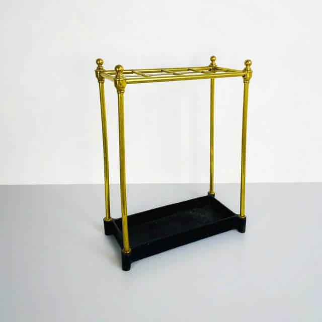 Italian mid-century brass umbrella stand with black iron base, 1950s Brass umbrella stand with eight holes and decorative...