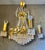 Very beautiful and richly executed vintage chandelier from the 1960s/70s, crafted in brass and fully fitted with cut prism...