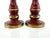 This striking pair of vintage turned wood candleholders showcases a richly layered red and green painted finish, accented...