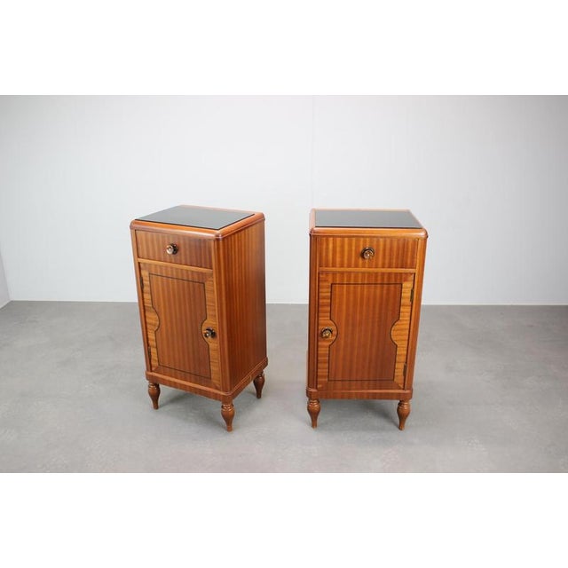 A refined pair of Art Deco bedside tables produced in Czechoslovakia during the late 1930s–40s. The cabinets showcase...