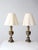 A pair of vintage 1970s brass table lamps in a refined Neoclassical urn form. Fluted bodies, stepped bases, and tall,...