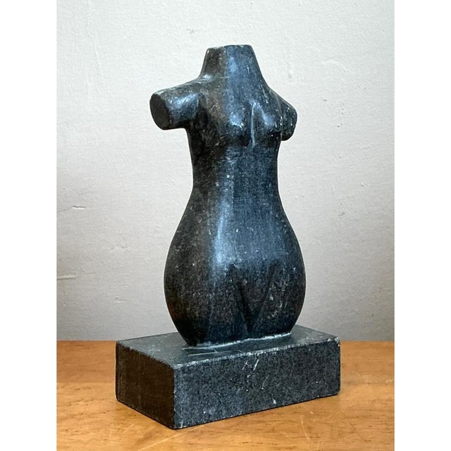 This vintage carved stone torso is a quietly powerful study in abstracted form, its female silhouette reduced to...