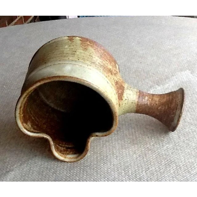 This vintage stoneware brown piece is uniquely designed with a side pour lip and a handle. As such, it may be used as a...