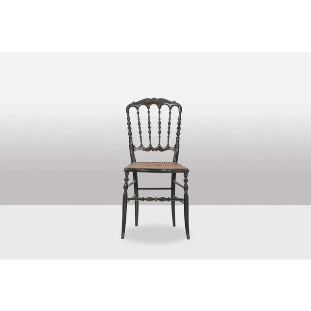 Chair in turned and blackened wood. Cane seat. Decorated with fine gilded work. French work from the Napoleon III period,...