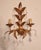 A stunning, hand-forged, handmade vintage wall sconce in a floral design, gilded in gold leaf with floral and leaf...