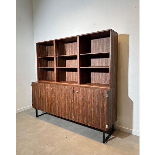Elegant French modernist wall unit attributed to Pierre Guariche, executed in beautifully grained rosewood veneer and...