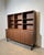 Elegant French modernist wall unit attributed to Pierre Guariche, executed in beautifully grained rosewood veneer and...