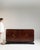 A sideboard whose dark mahogany, black lacquer trim, open door with drawers gives it real character at first glance. It...