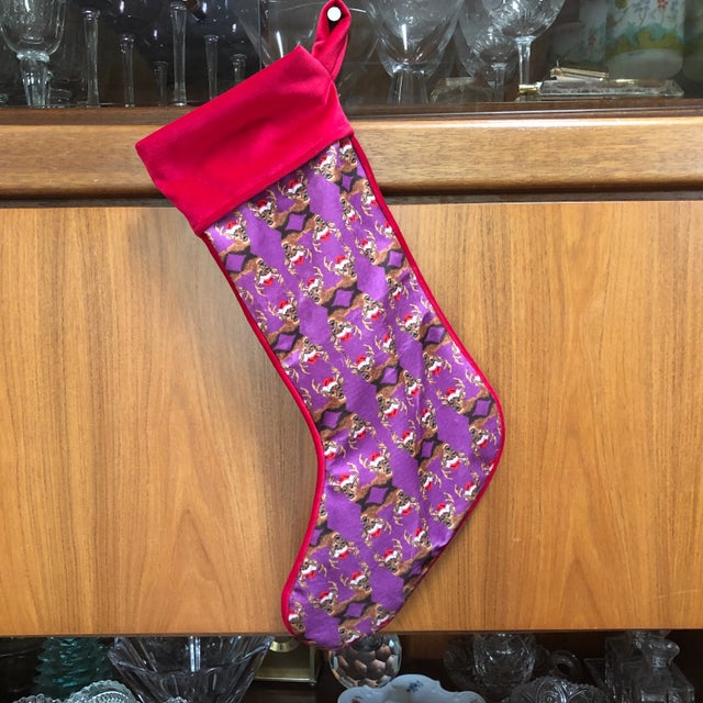 Dashing bucks in Santa hats create a striking and playful silhouette to this fabulous stocking! Mommani private label...
