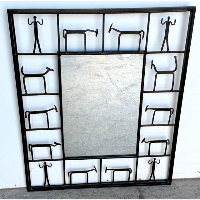 Figural Iron Wall Mirror by Frederick Weinberg, American, Mid-20th Century This sculptural figural iron wall mirror by...