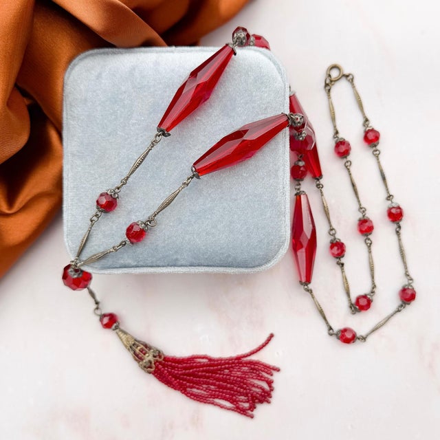 This elegant beaded necklace dates from c.1900. Condition Report: Good - The metal capping for the tassel is slightly mis-...