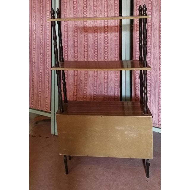 Mid-century étagère bookcase with sliding doors made of veneered plywood with black painted turnings, original from the...