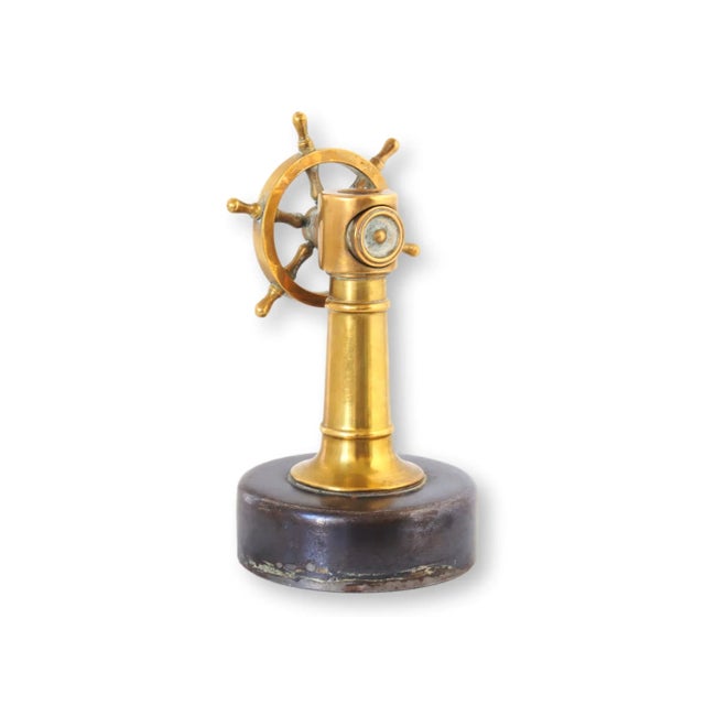 This Antique English Brass Ship's Wheel Cigar Cutter is a nautical treasure with a utilitarian twist. Its gleaming brass...