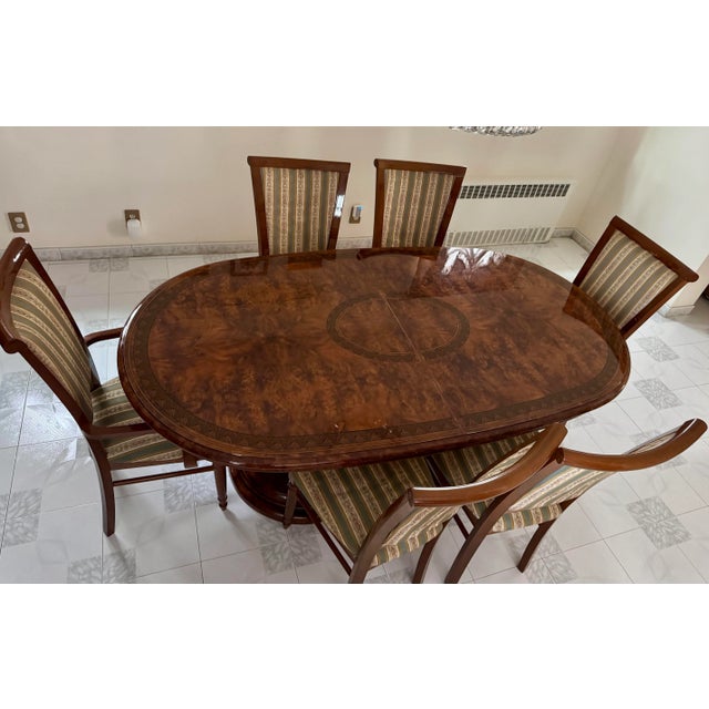 A striking Eddi Rose Collection dining set in the classic European style, circa early 2000s. The oval table features a...