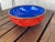 A vintage Chinese carved cinnabar laquerware bowl with relief floral decoarion, probably mid 20th century. Features a blue...